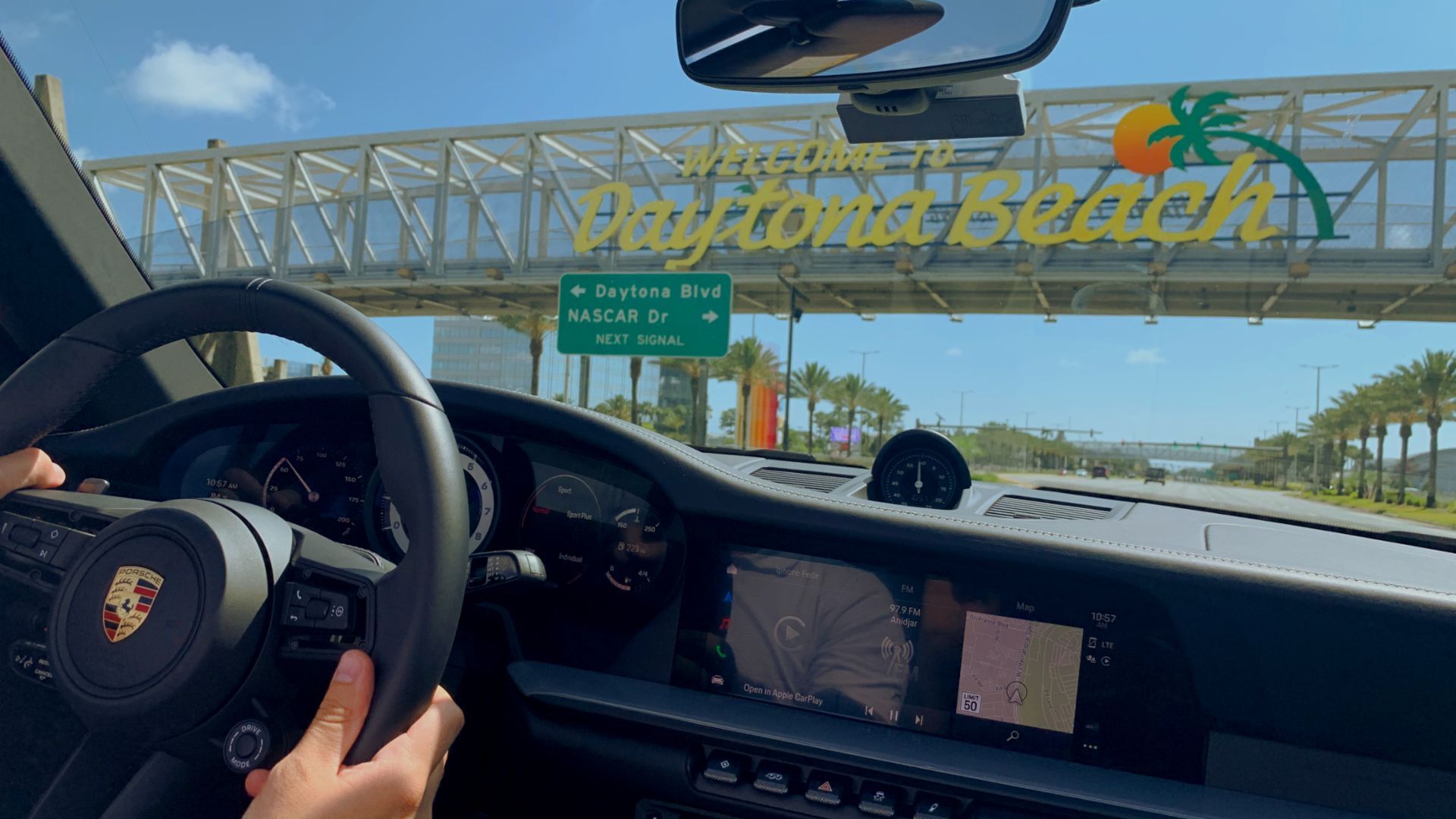 Porsche driver passing under the Welcome to Daytona Beach sign in Florida.