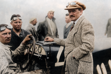1924 Targa Florio and shows Alfred Neubauer at the wheel with Ferdinand Porsche standing at the right side of the car.