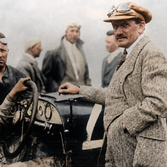 1924 Targa Florio and shows Alfred Neubauer at the wheel with Ferdinand Porsche standing at the right side of the car.