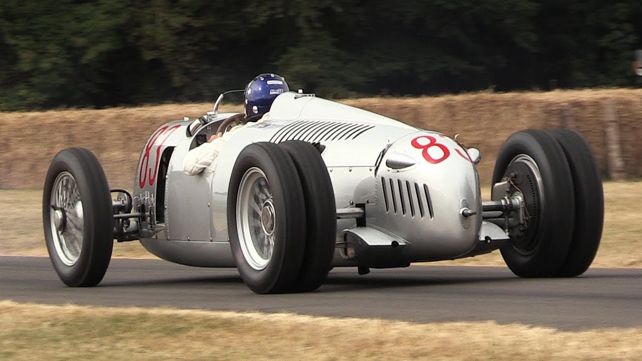 The 1936 Auto Union Type C represented the peak of Ferdinand Porsche’s original V16 Grand Prix concept. Its six-liter, supercharged engine produced roughly 520 horsepower, delivering immense torque through narrow tires and a chassis that demanded exceptional strength, precision, and courage from its driver. With Bernd Rosemeyer at the wheel, the Type C became one of the defining racing cars of the prewar era and one of the clearest early demonstrations of the competitive potential of placing the engine behind the driver.