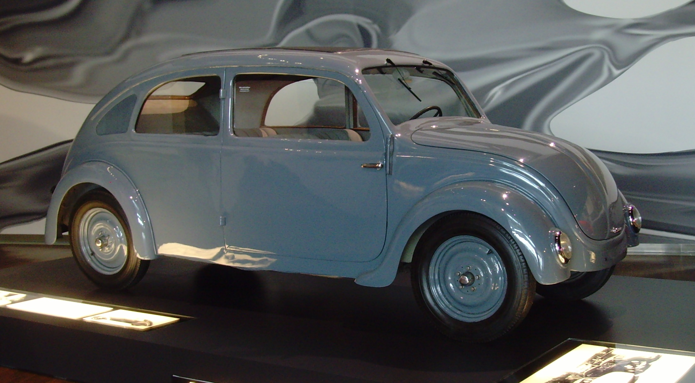 The Porsche Type 32, developed for NSU in 1933, brought Ferdinand Porsche’s small-car ideas much closer to the form later associated with the Volkswagen. Its rear-mounted, air-cooled flat engine, rounded aerodynamic body, and compact torsion-bar suspension reflected a growing effort to design the entire automobile around efficiency, space, and low production cost. Although NSU’s business arrangements prevented the project from reaching production, the Type 32 gave Porsche’s team valuable experience refining the rear-engine architecture. It was not yet the Volkswagen, but it was an important step toward it.