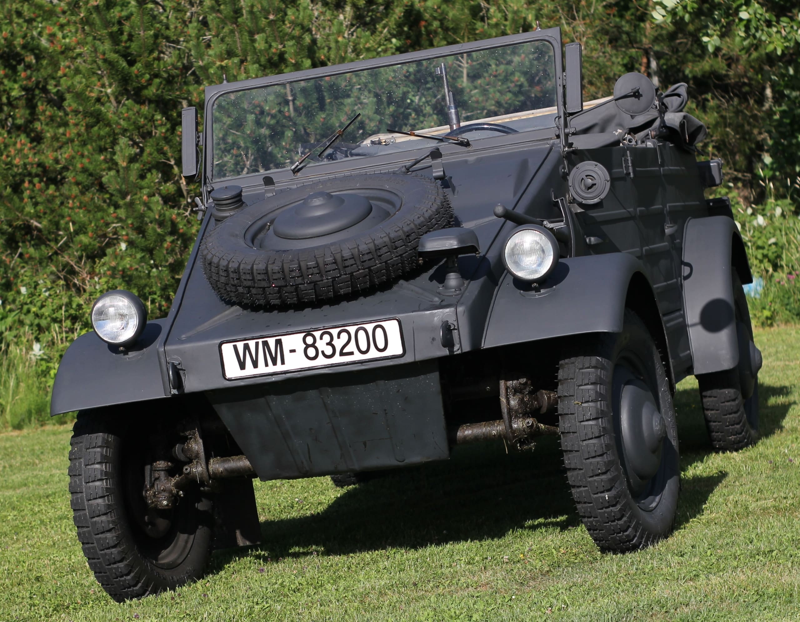 Following the outbreak of war in September 1939, the Volkswagen project was redirected away from civilian production and toward military requirements. The Type 82 Kübelwagen adapted the basic rear-engine Volkswagen architecture into a lightweight, open-bodied field vehicle designed for simplicity, durability, and ease of maintenance. Although it lacked conventional four-wheel drive, its low weight, rear-mounted engine, specialized gearing, and generous ground clearance gave it impressive mobility across sand, mud, snow, and damaged roads. Its air-cooled engine also eliminated the vulnerable radiator and coolant systems found in many other vehicles, making the Kübelwagen especially useful in extreme climates. What had begun as the mechanical foundation for an affordable family car had become one of Germany’s most practical military transport vehicles.
