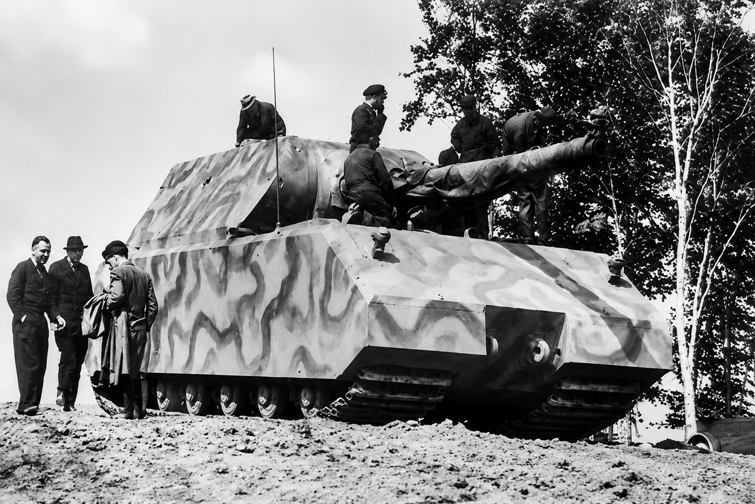 The Panzer VIII Maus represented the most extreme expression of Ferdinand Porsche’s wartime armored-vehicle work. Developed as a super-heavy tank, the Maus was intended to combine massive armor protection with overwhelming firepower, and Porsche played a central role in its engineering, including the continued use of his favored electrical transmission concepts to manage the enormous weight and power demands involved. In many ways, the project reflected both his brilliance and his excesses: technically ambitious, mechanically fascinating, and entirely willing to ignore ordinary limits of size and complexity. Yet the Maus also exposed the growing disconnect between spectacular engineering and battlefield reality, as its immense weight created crippling problems involving mobility, transport, fuel consumption, and practical military usefulness. Only prototypes were completed, leaving the Maus less as a successful weapon than as a powerful symbol of how far Porsche’s technical ambition had been drawn into the regime’s increasingly unrealistic search for extraordinary machines.
